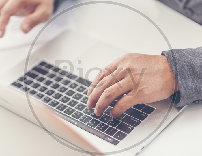 Young Business Man Working Over Laptop With Hands On Keyboard