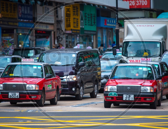 Taxi Cars Waiting At  A Traffic Signal In Hong Kong City