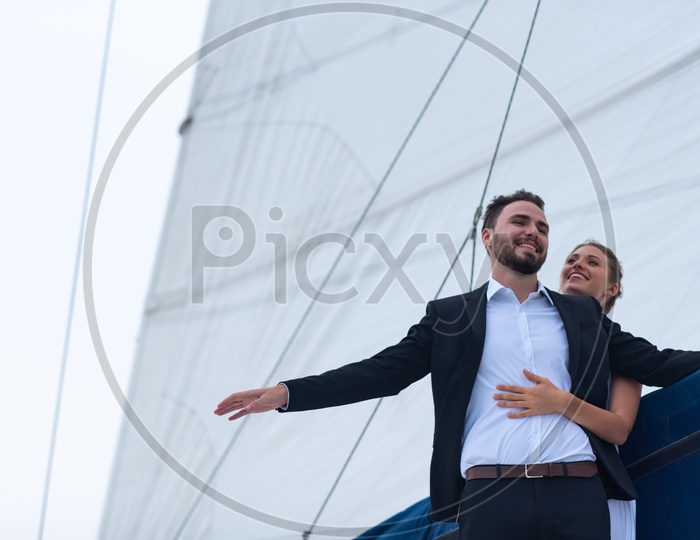 Business couple  celebrating in a yacht, Honeymoon summer trip