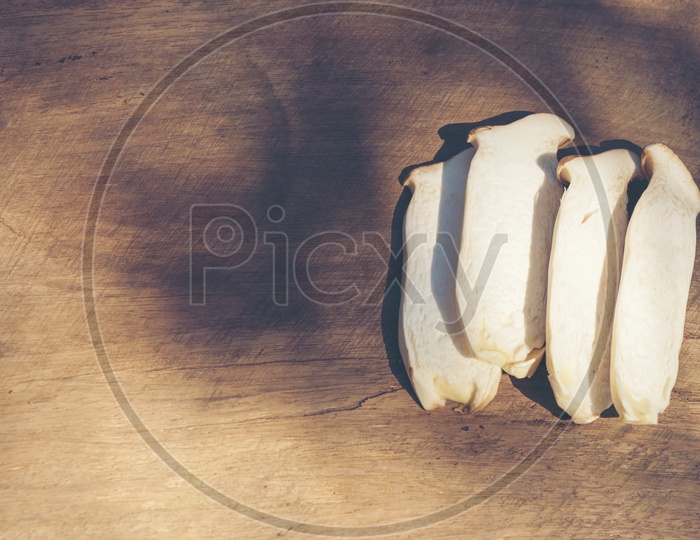 Processed sliced mushrooms on a wooden background