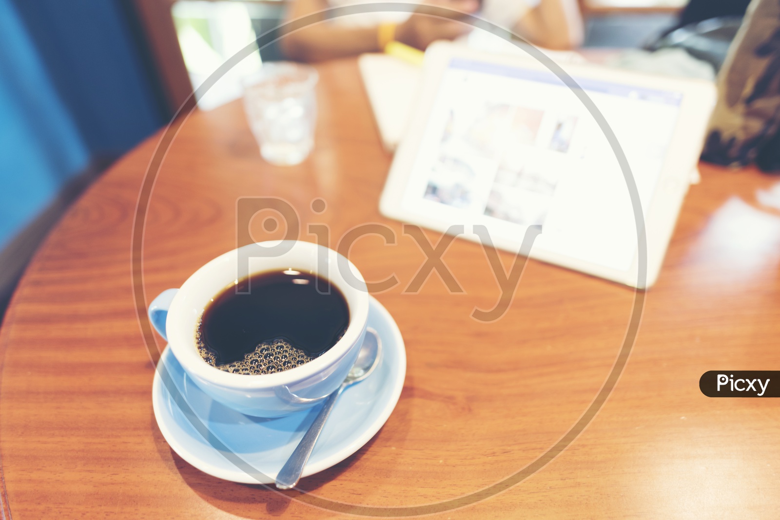 Black americano coffee in ceramic white cup on a wooden table