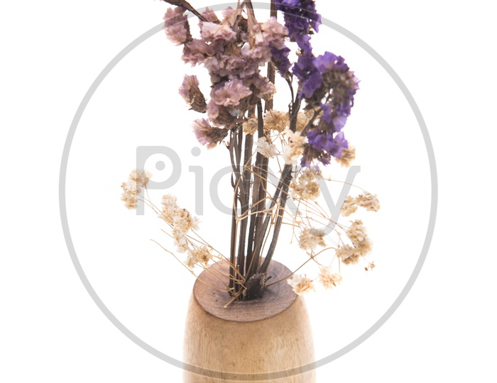Dried vintage flowers in a wooden vase isolated on white background.