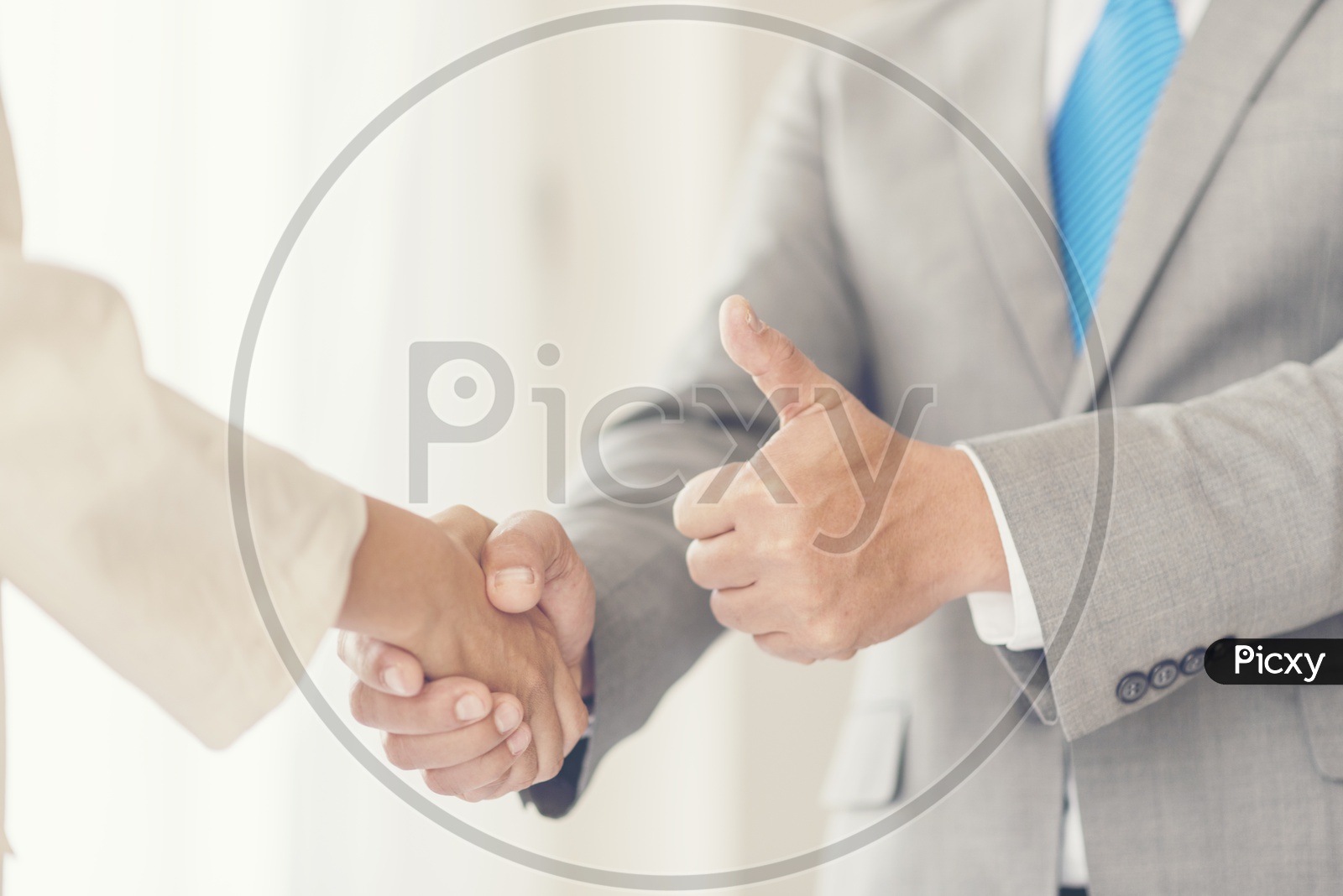 Business Success Greetings Concept With Business Partners Shaking Hands And Thump up Gesture Closeup