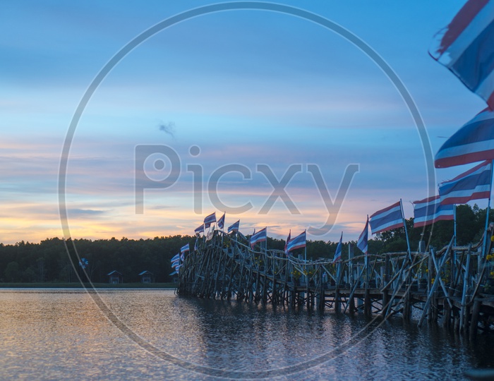 Lake with Wooden Bridge Or Pier With Sunset Blue hour Sky