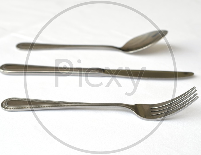Fork spoon and knife on the table Over a White Background
