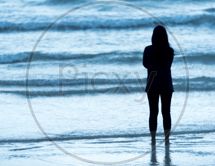 Silhouette Of An Lone Woman Standing at a Beach