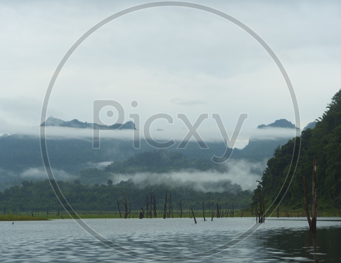 Tropical Lake With Green Mountains In Backdrop