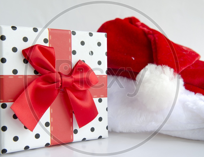 Santa Cap  with Gift Box For Christmas On an Isolated White Background