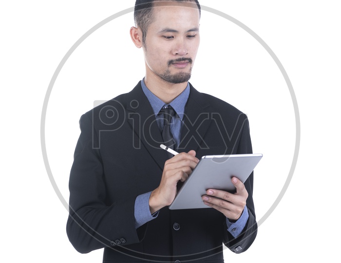 Young businessman Using  a digital tablet or ipad  isolated on a white