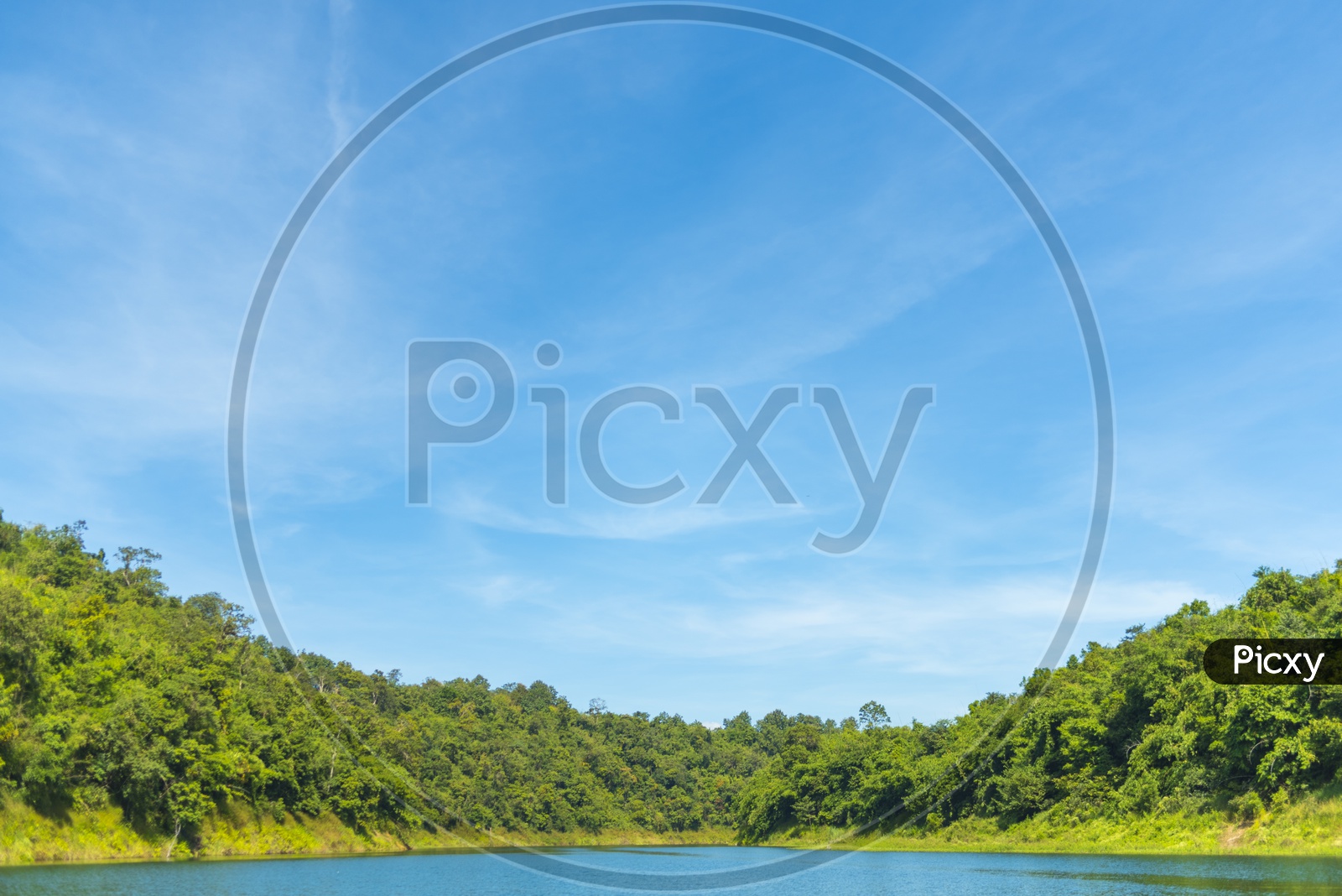 Tropical Lake In a Forest With Blue Sky As a Background