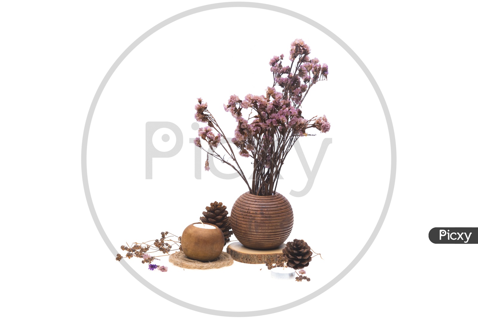 Dried pink flowers in a wooden vase and candles isolated on white background