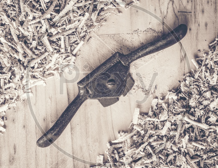 Carpenter tools on wooden table with sawdust.