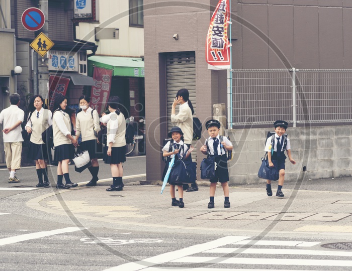 Japanese young students are coming back from elementary school in Kyoto, Japan.