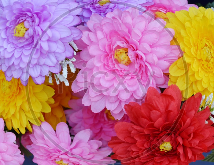 Colourful Artificial Flowers Filled Background