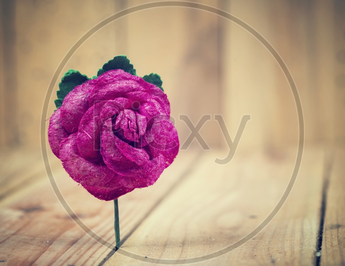 vintage rose flower Alone Over Wooden Background With Selective Focus