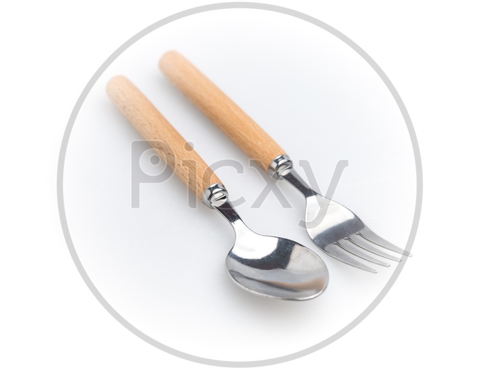 Spoon and fork with wooden handle isolated on white background