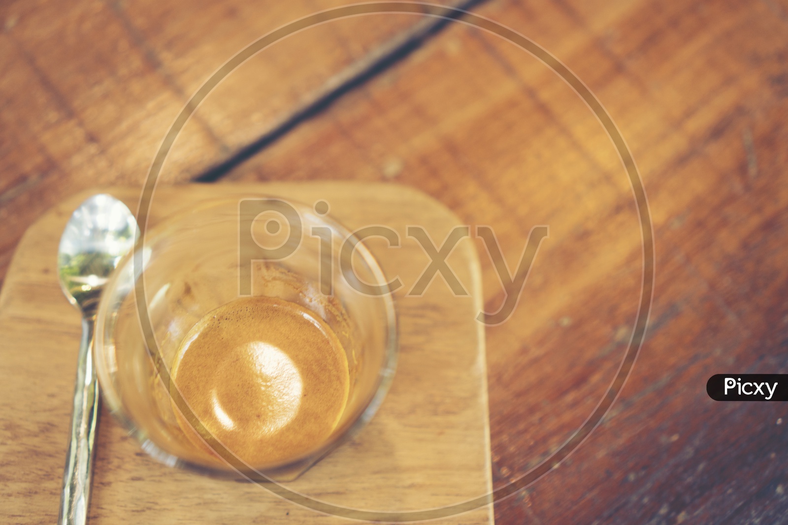 Coffee Drip in a Glass over Wooden Background