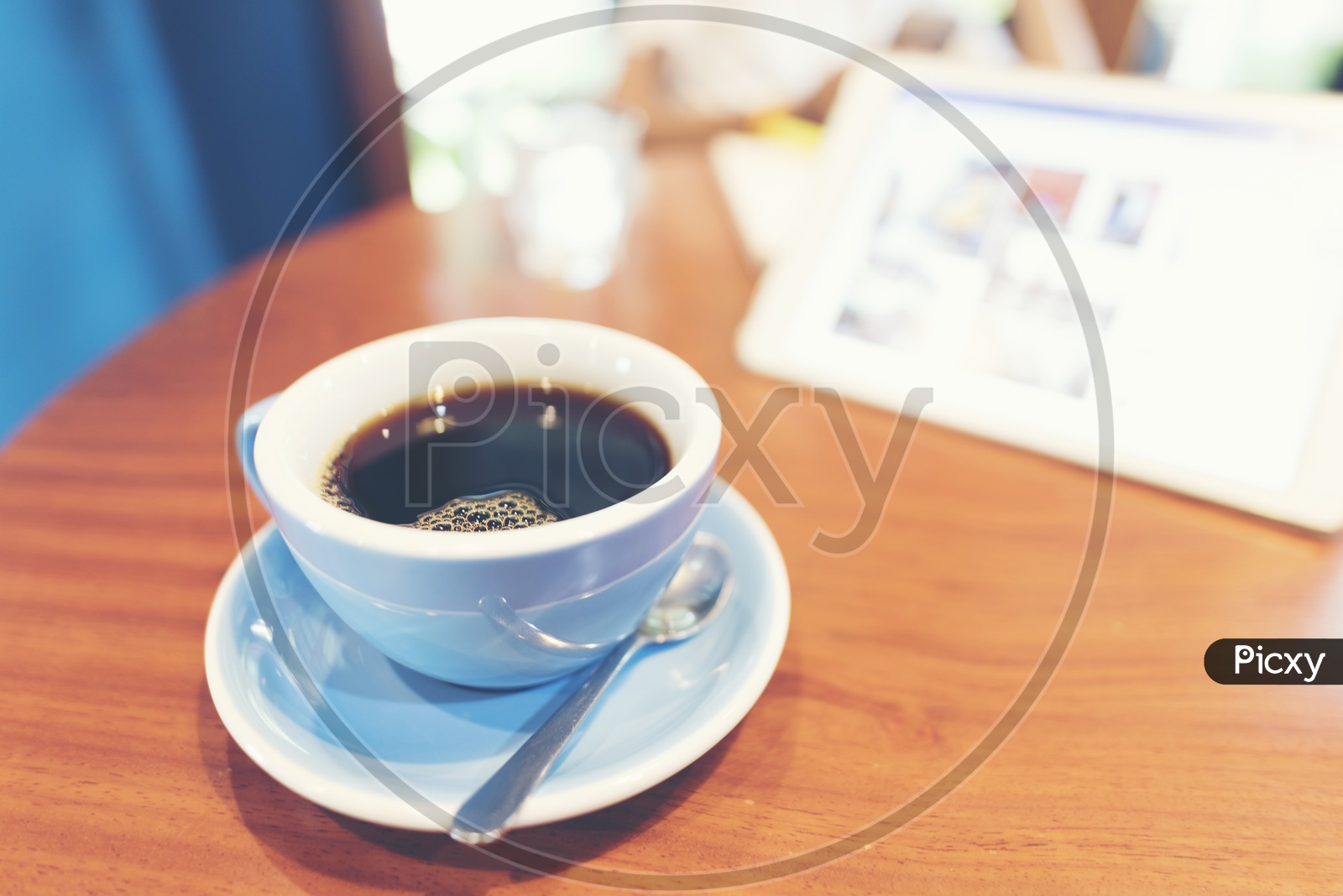 Close up of Black americano coffee in ceramic white cup on a wooden table