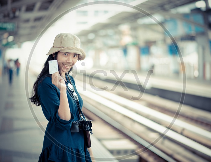 Asian traveler women on sky train station Showing Metro Train Card