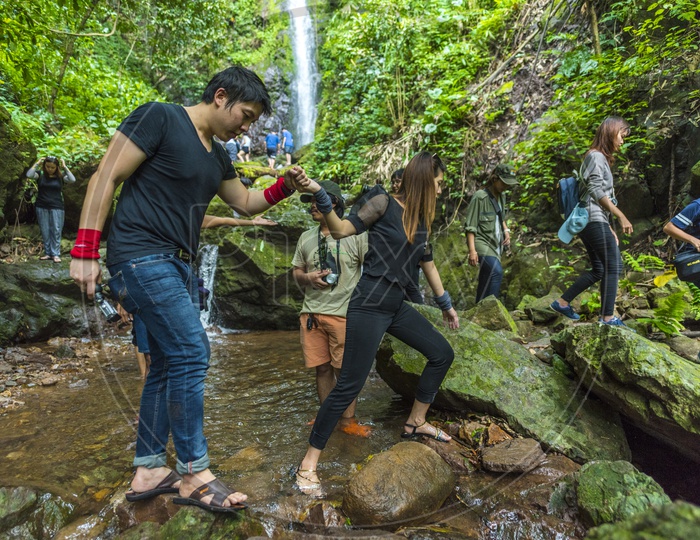 Group Of Adventure Travelers Trekking in Nature At Khao Yai National Park In Thailand