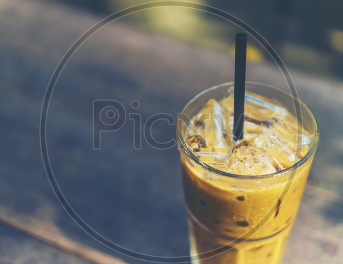 ice coffee glass on wooden table in cafe