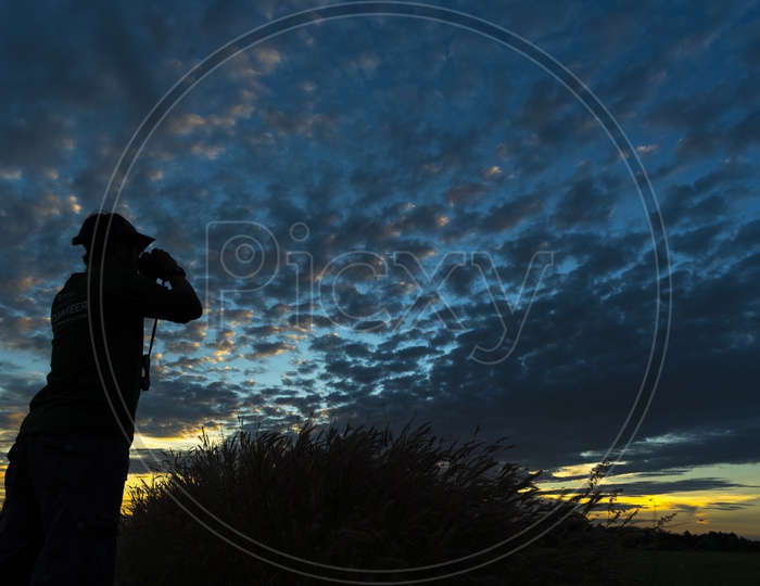 Silhouette Of a Man Over an Blue Hour Sky With Clouds