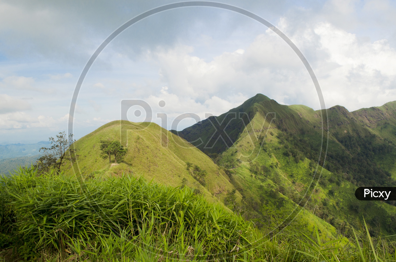 A Landscape With Green Mountains Peaks And Sky With Cotton Clouds at Khao Chang Phueak Pilok
