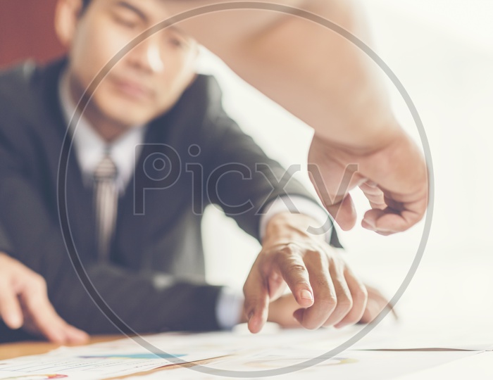 Close up of a man finger pointing a document