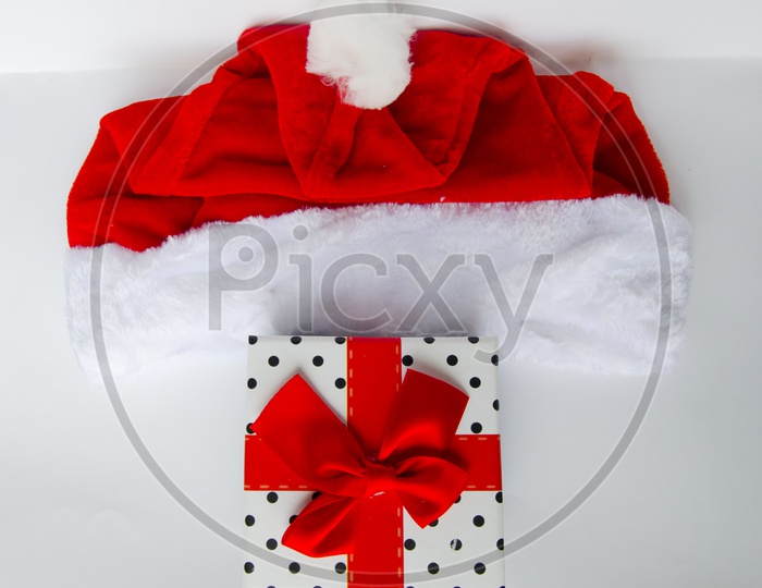 Present for Christmas With gift Box and Santa Hat On an Isolated White background