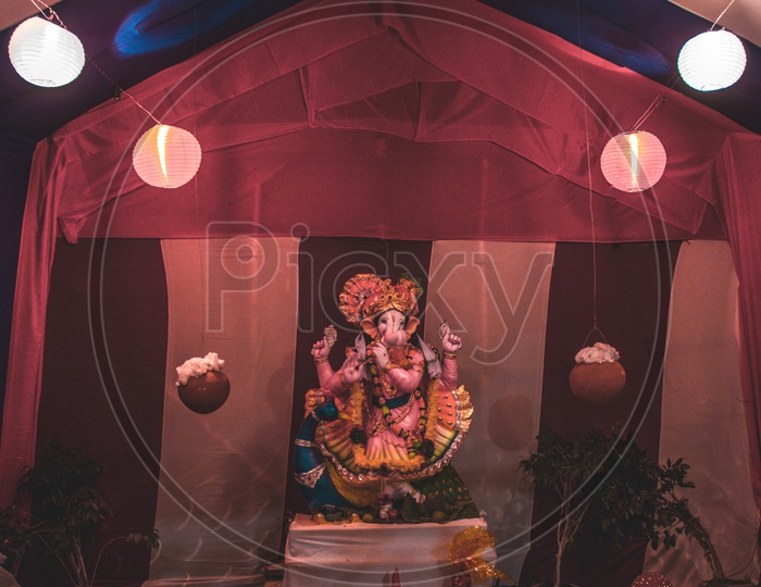 Ganesha idol in between lights