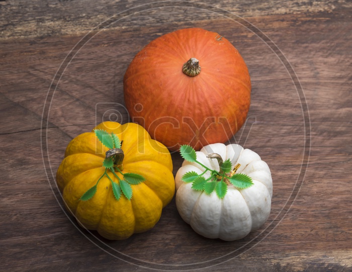 Raw pumpkins on wooden table, top view