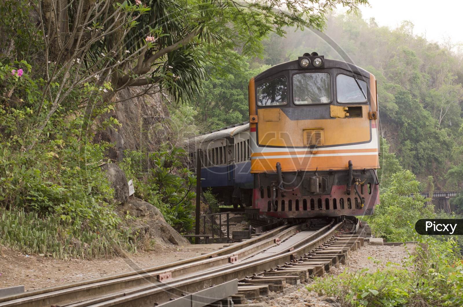 Train Running On The Narrow Gauge Track At Thailand-Burma Railway Line Built During World War II