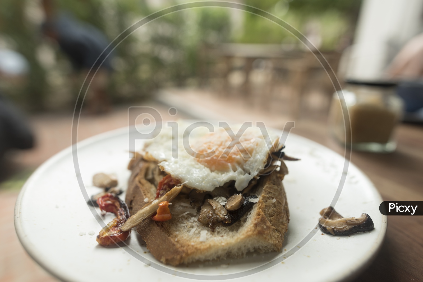 Thai Breakfast With Bread Omelet  and Beef Pieces Served At a Restaurant Table Background