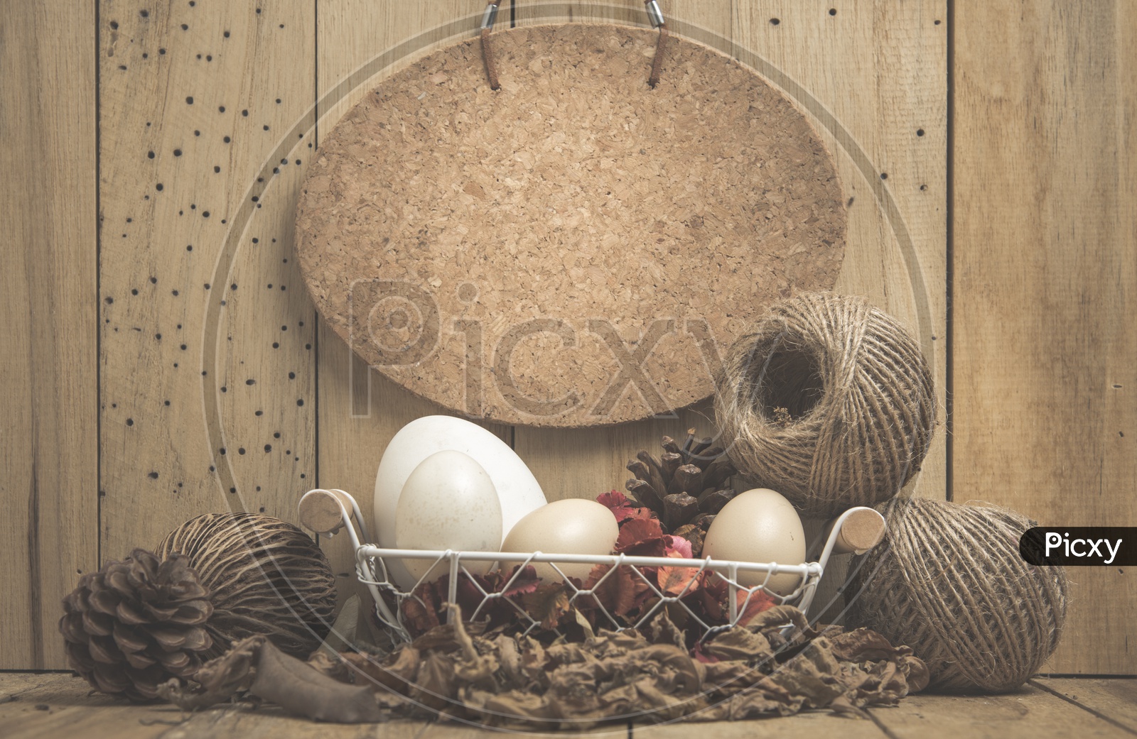 Eggs In a Basket Over Vintage Wood Background