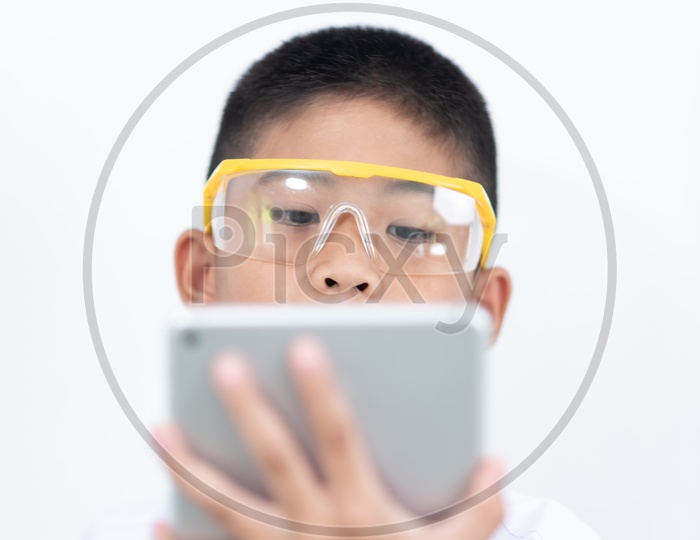 Curious boy Enjoying Learning In a Laboratory With IPAD