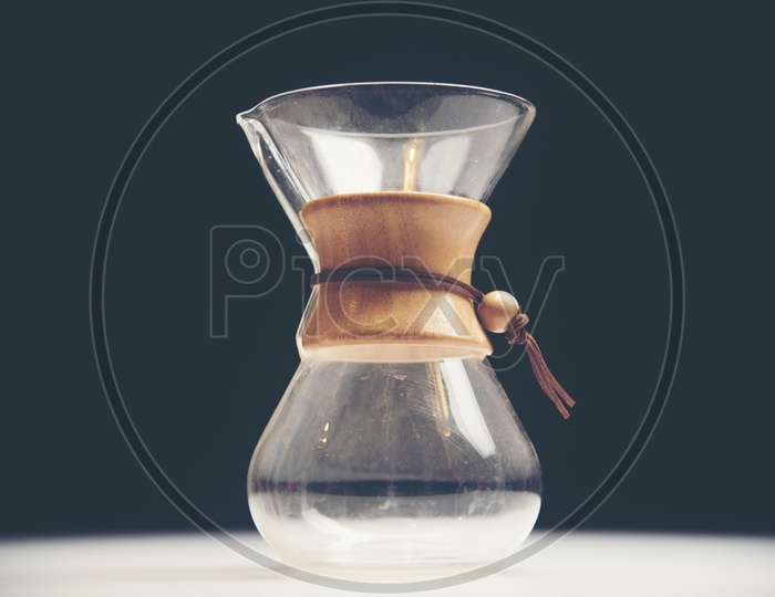 Glass jar of coffee drip isolated on black