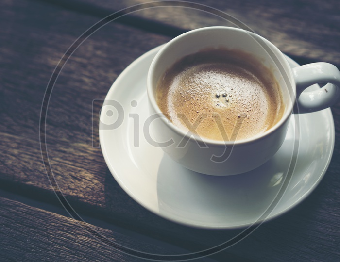 coffee cup on old wooden table background