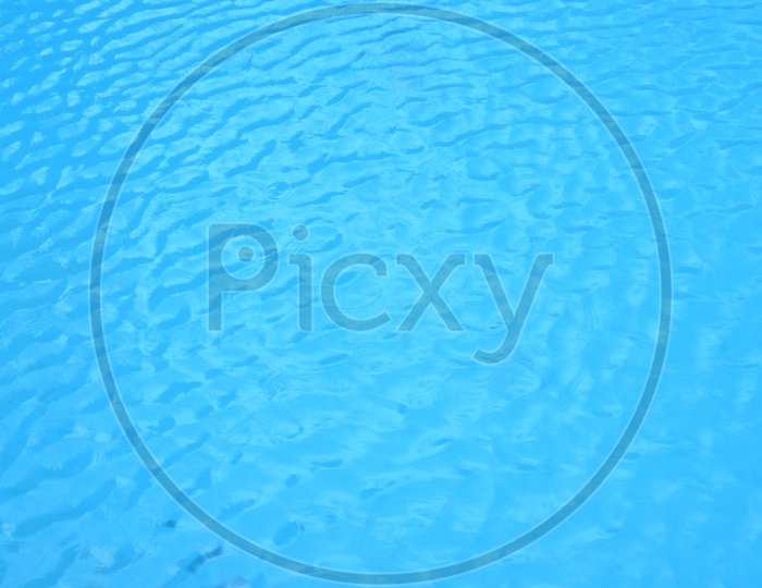 Blue Water Surface Of a Swimming Pool With Ripples