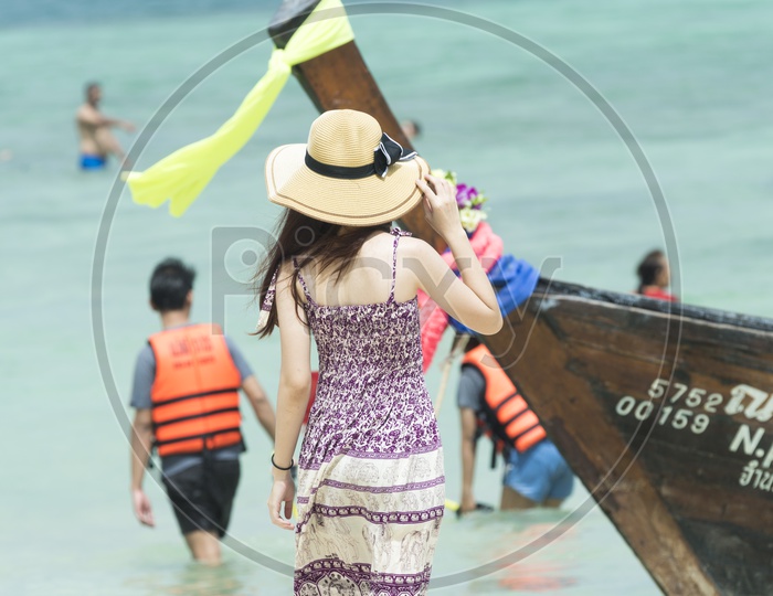 A Woman in Phuket Beach Standing at Tourist Boat