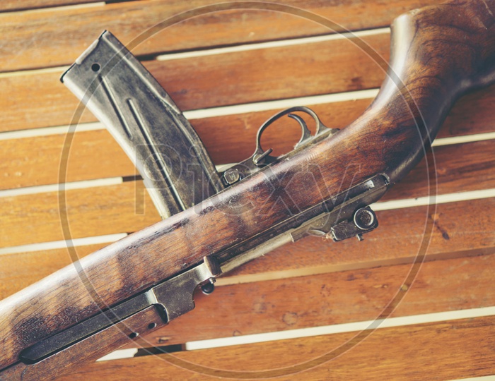 Ancient Machine Gun Used in World War II  On Wooden Background