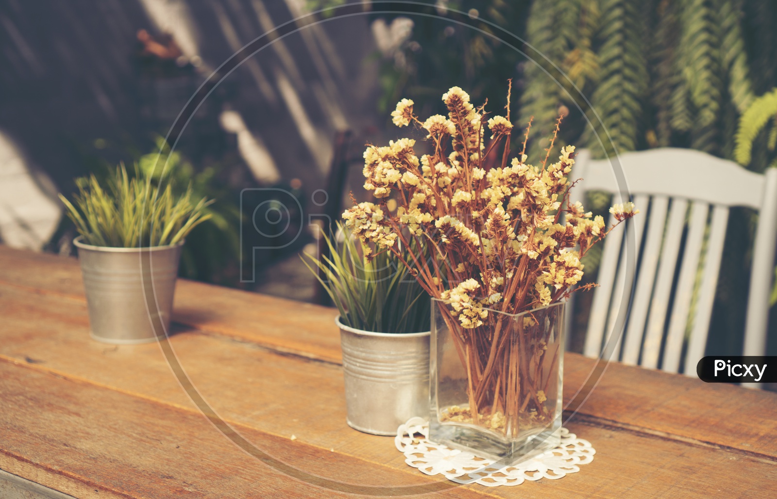 dry yellow flowers in a Vase  on table in a Cafe Or restaurant
