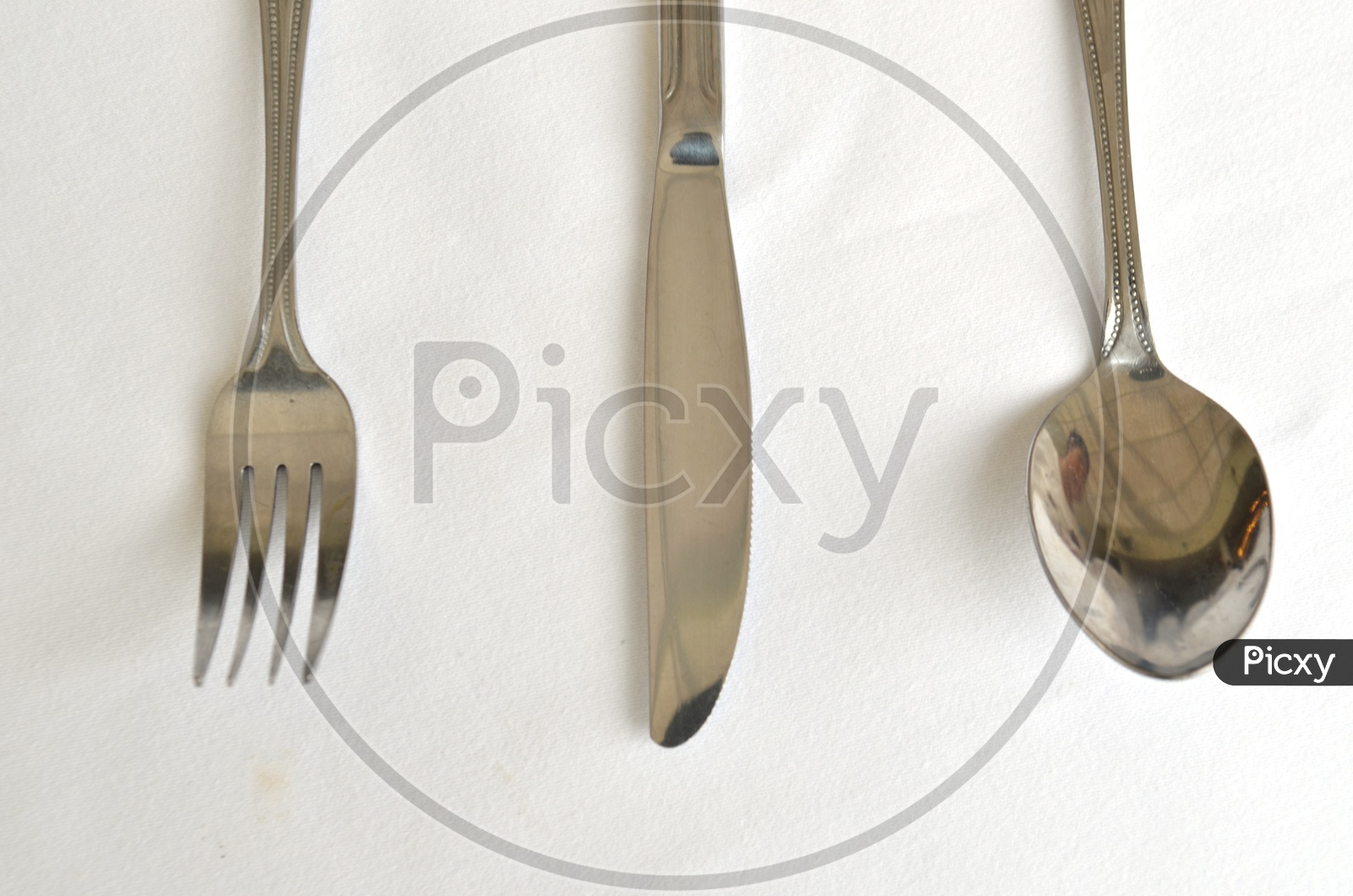 Fork spoon and knife on the table Over a White Background
