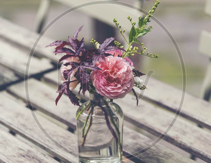 Beautiful Flowers In a Vase On an Wooden Table
