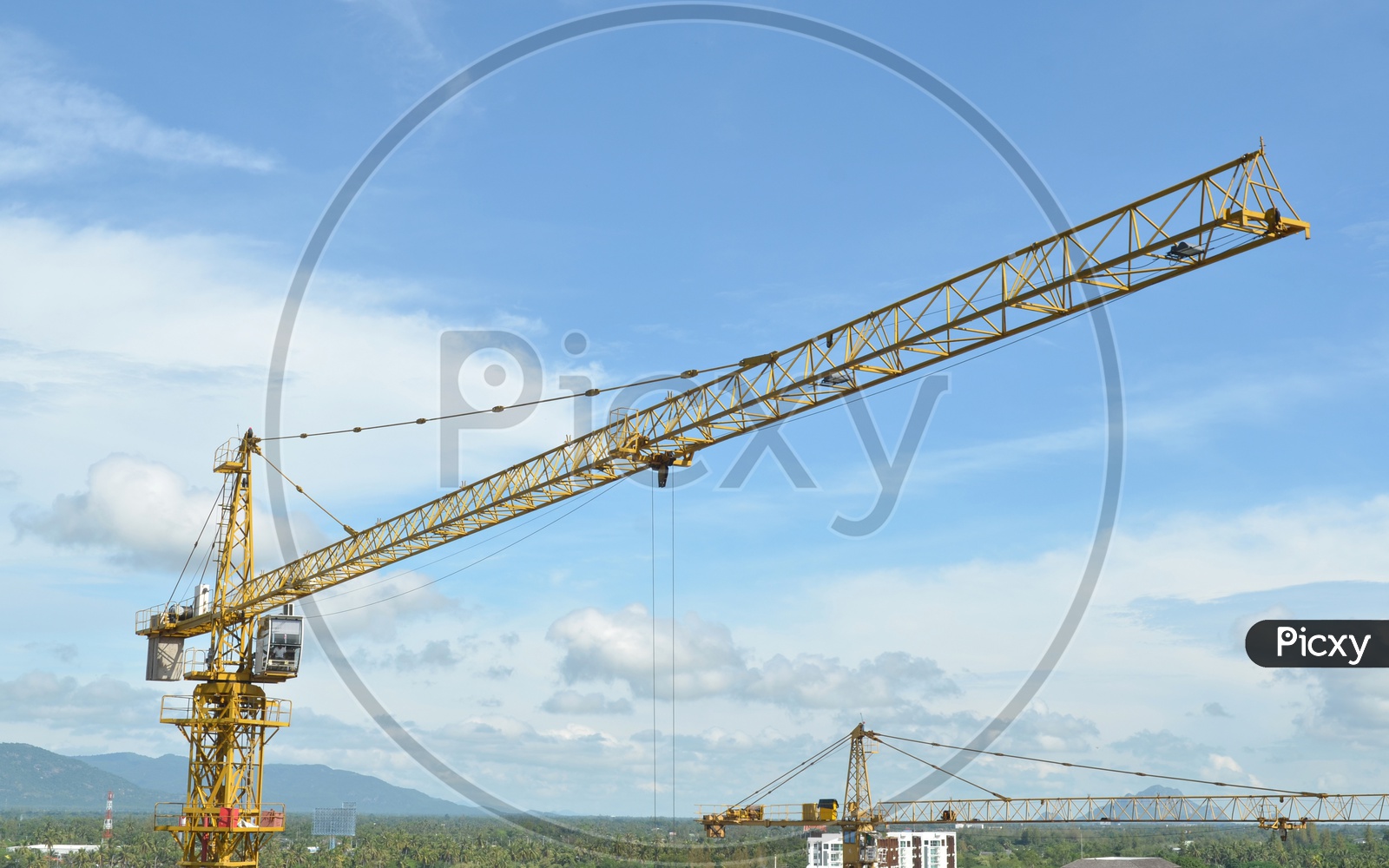 A View of Heavy Crane and building working progress At construction site