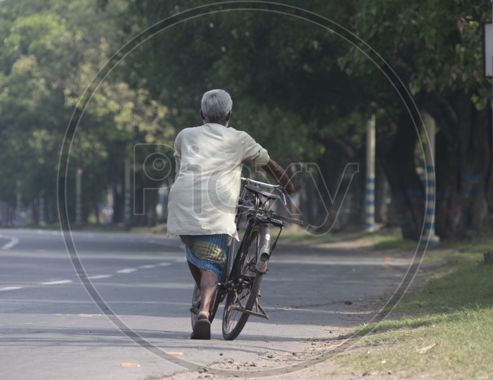 Indian Old Man riding bicylce