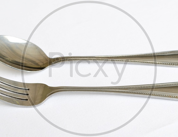 Fork spoon and knife on a White  table