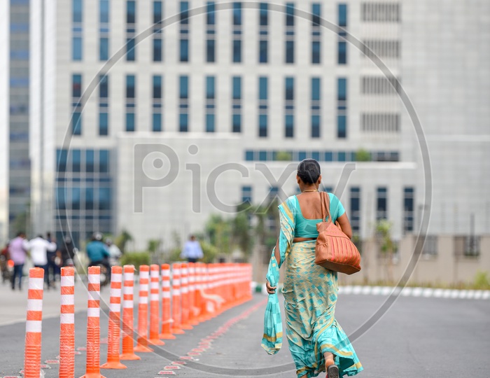 A Woman Wearing Saree Or Sari Walking Towards Corporate Office