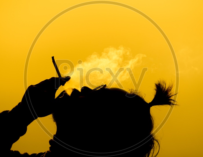 Black silhouette of a Man Smoking Cigarette
