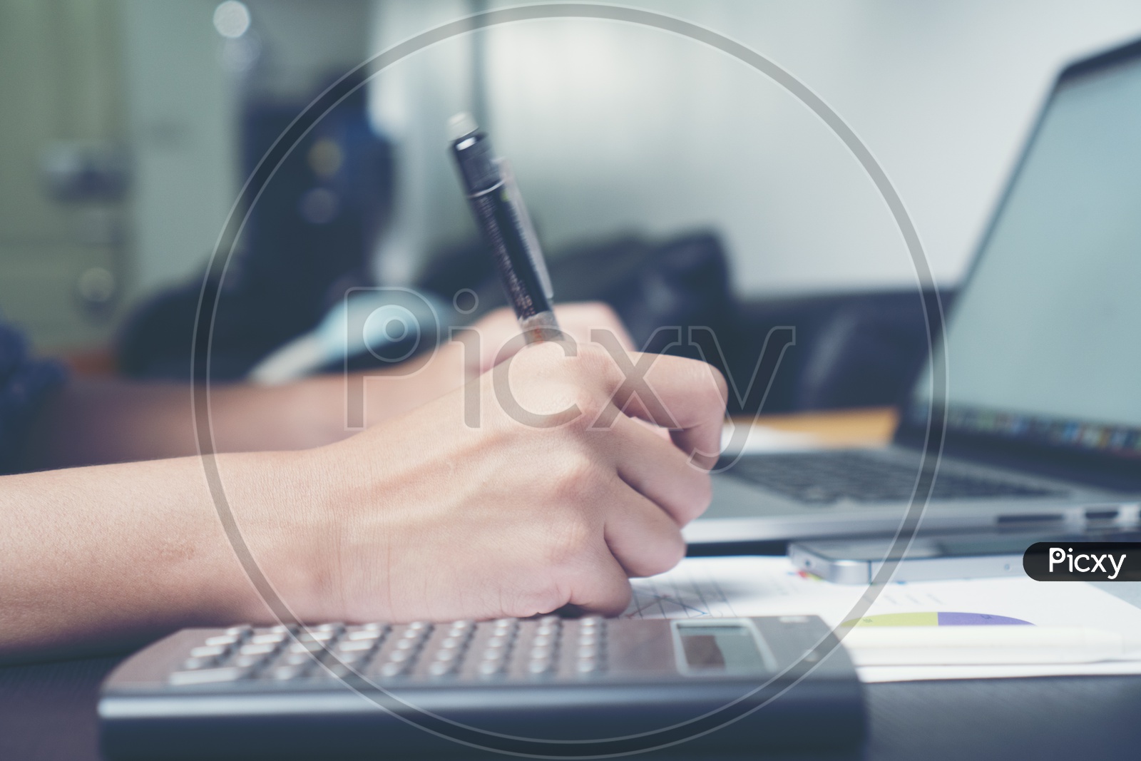 Employee Or Businessman Working On Laptop With Paperwork Of Business Analysis Charts At Office Desk With Hands Closeup