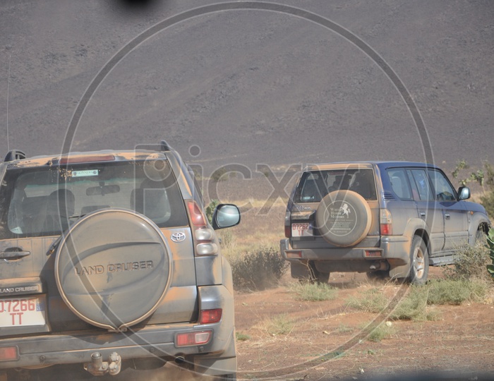 Toyota Land cruiser Cars moving in a desert covered with mud